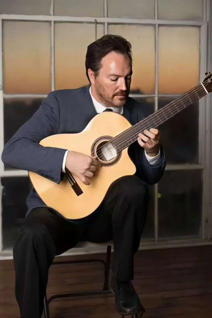 Classical guitarist Marcus Gerakos holding his guitar