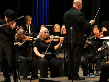 Young violinist performs on stage alongside La Mirada Symphony musicians
