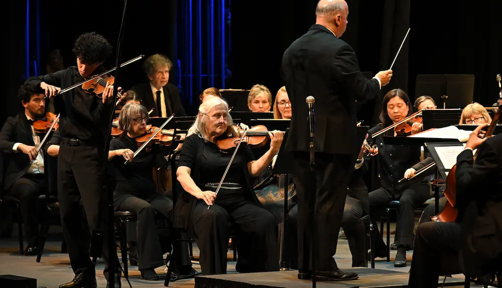 Young violinist performs on stage alongside La Mirada Symphony musicians