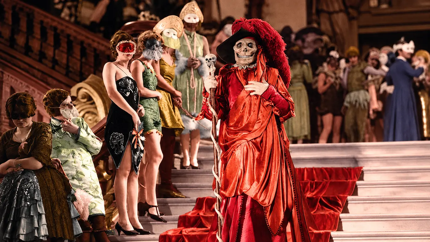 Lon Chaney as the Red Death in a crimson costume at the masquerade ball in The Phantom of the Opera (1925).