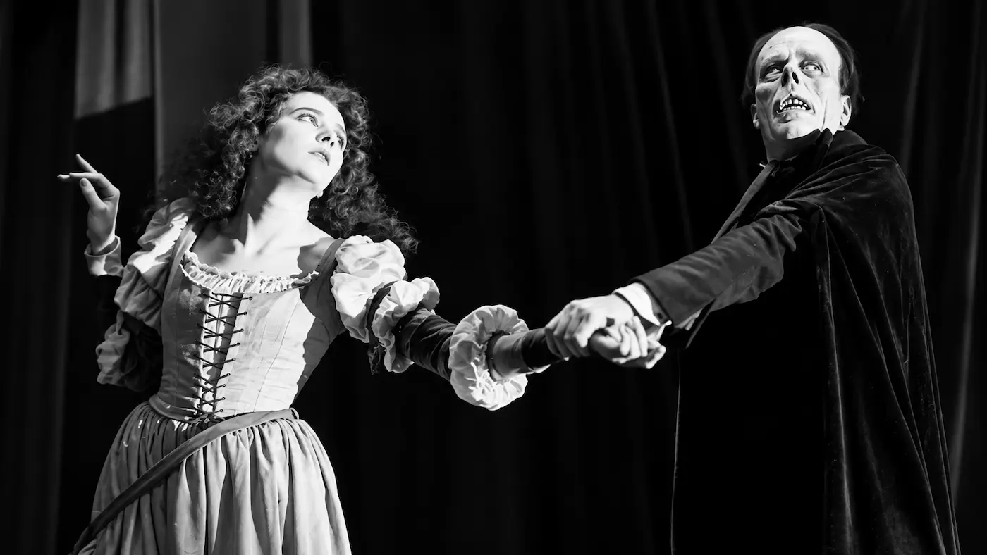 Black-and-white recreation of the Phantom holding Christine's hand as she pulls away, inspired by Lon Chaney and Mary Philbin in The Phantom of the Opera (1925).